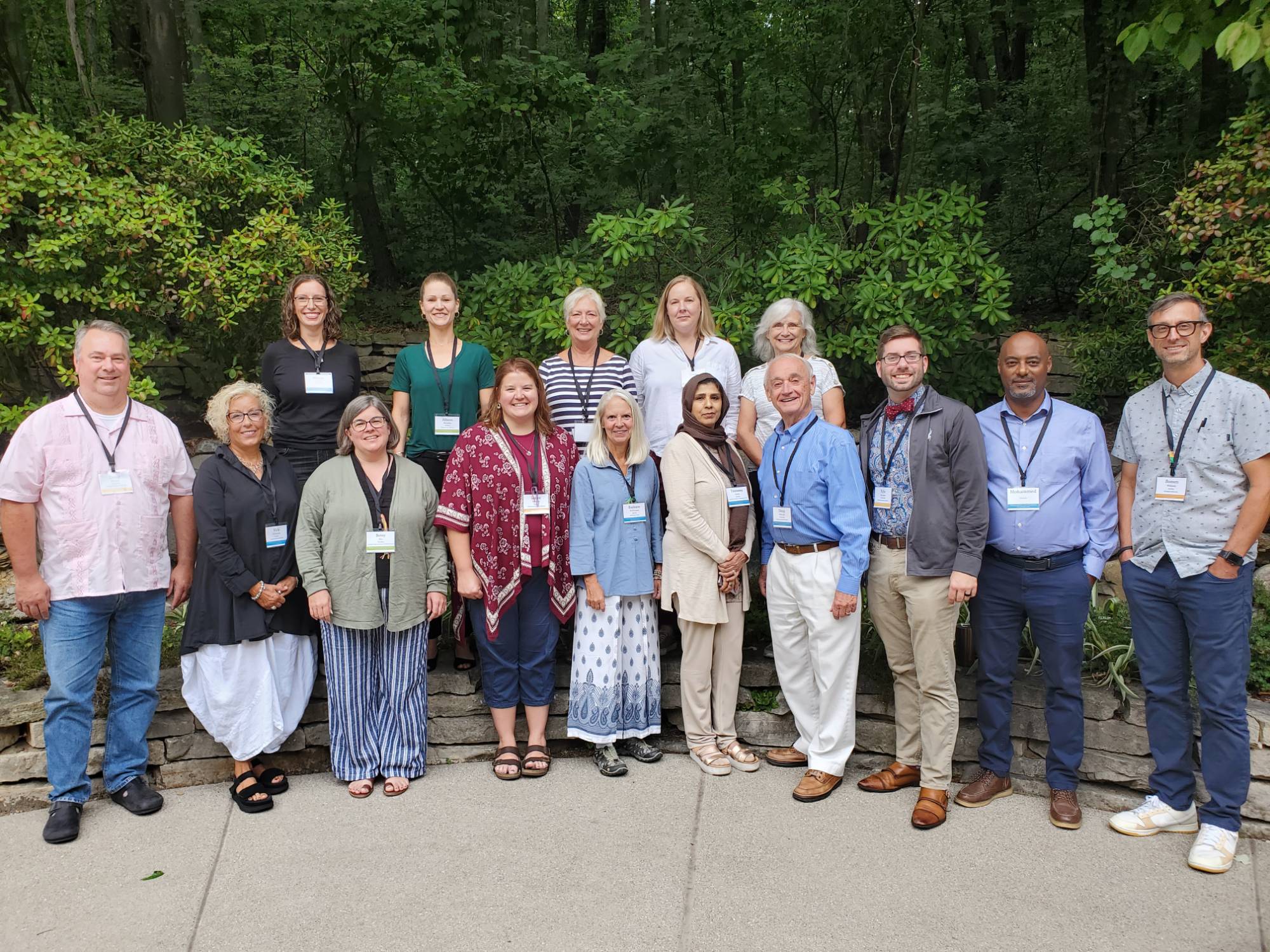Picture of convening attendees standing in a line outsite